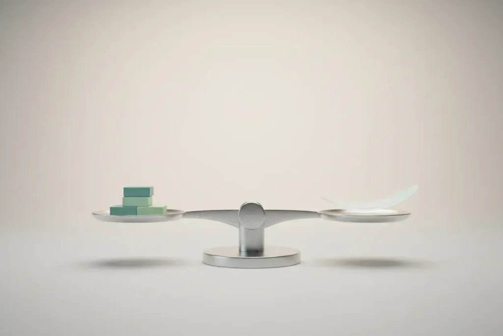 Minimalist balance scale with a feather and neat stacked blocks on level pans, centered on a soft neutral background.